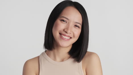 Asian-woman-winking-and-pointing-straight-to-camera.