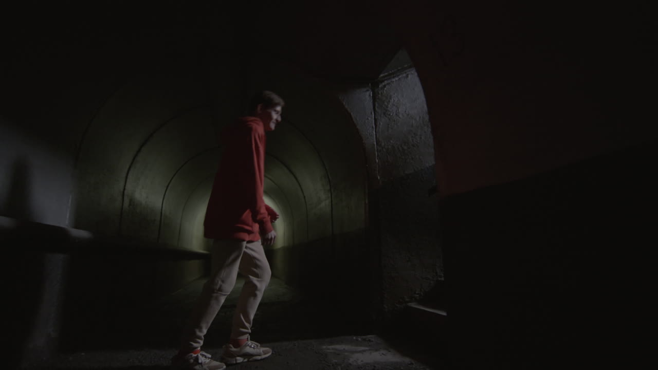 Parkour Athlete Running Upstairs from Dark Tunnel