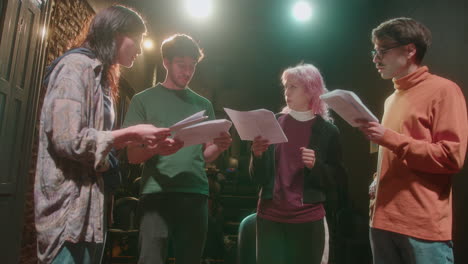 theater actors reading scripts on rehearsal or acting class