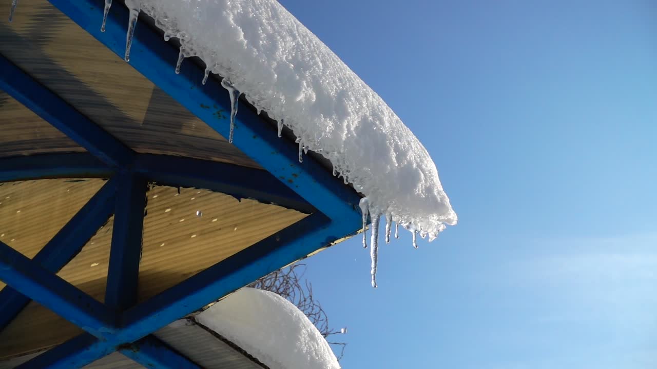 The water dripping from icicles. Shooting in the winter. Slow motion
