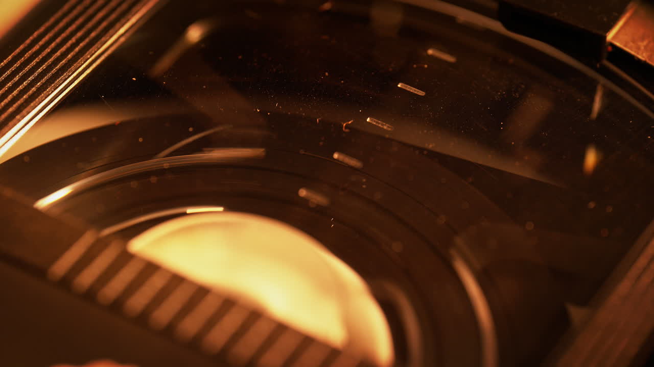 Rewinding the Video Tape Inside of the Dusty Plastic Cassette Shell - Macro, Warm 90s Mood