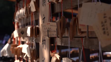 slow close up rotating shot of wooden wishing cards at japanese shrine