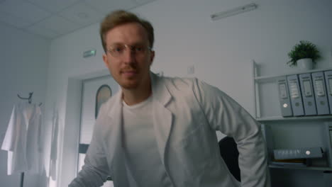 man therapist consulting remotely in clinic close up. physician greeting patient