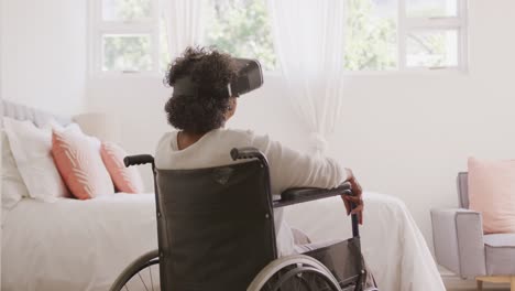 Senior-mixed-race-woman-sitting-on-a-wheelchair.-Social-distancing-and-self-isolation-in-quarantine-