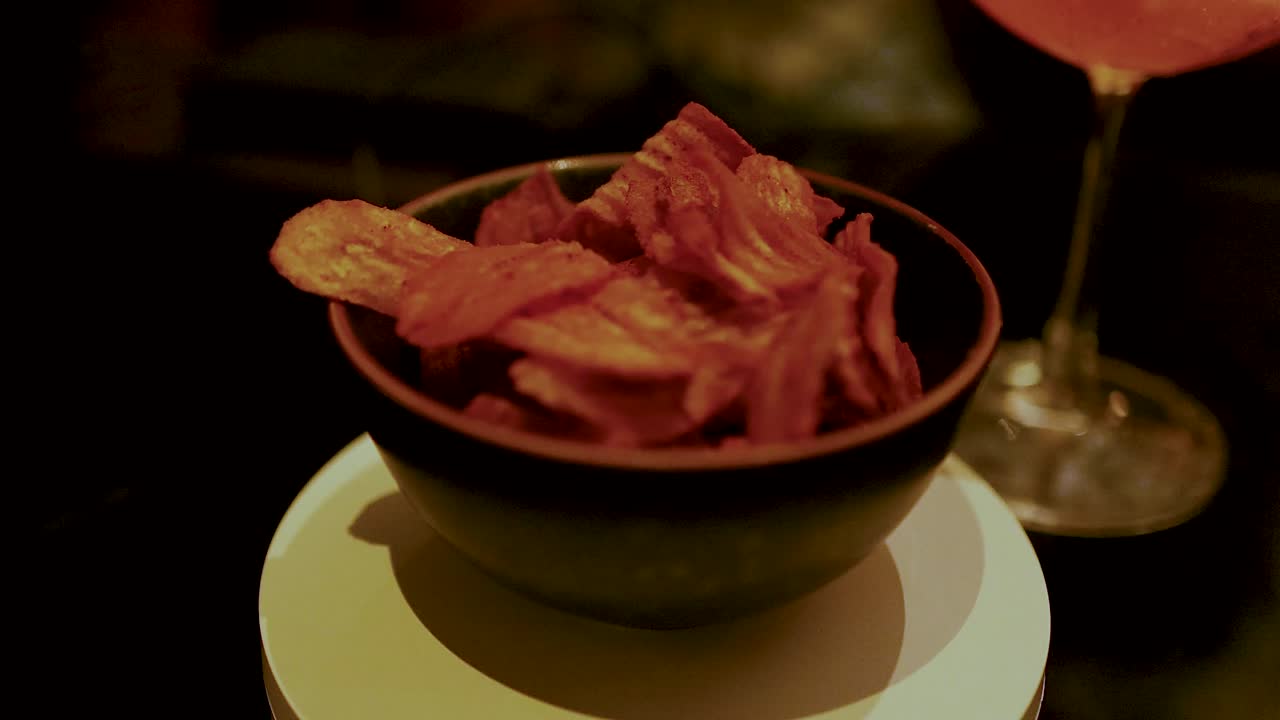 Chips and cocktail on a table in Bangkok