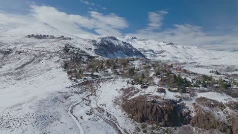 Aerial-establishing-shot-of-skiing-resorts-and-run-in-the-Andes,-Chile