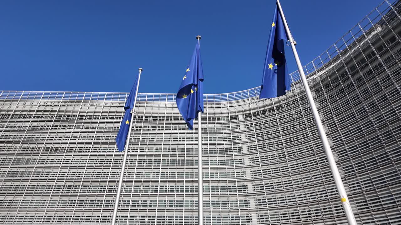 European Union flags waving in front of Berlaymont Building