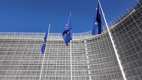 european union flags waving in front of berlaymont building