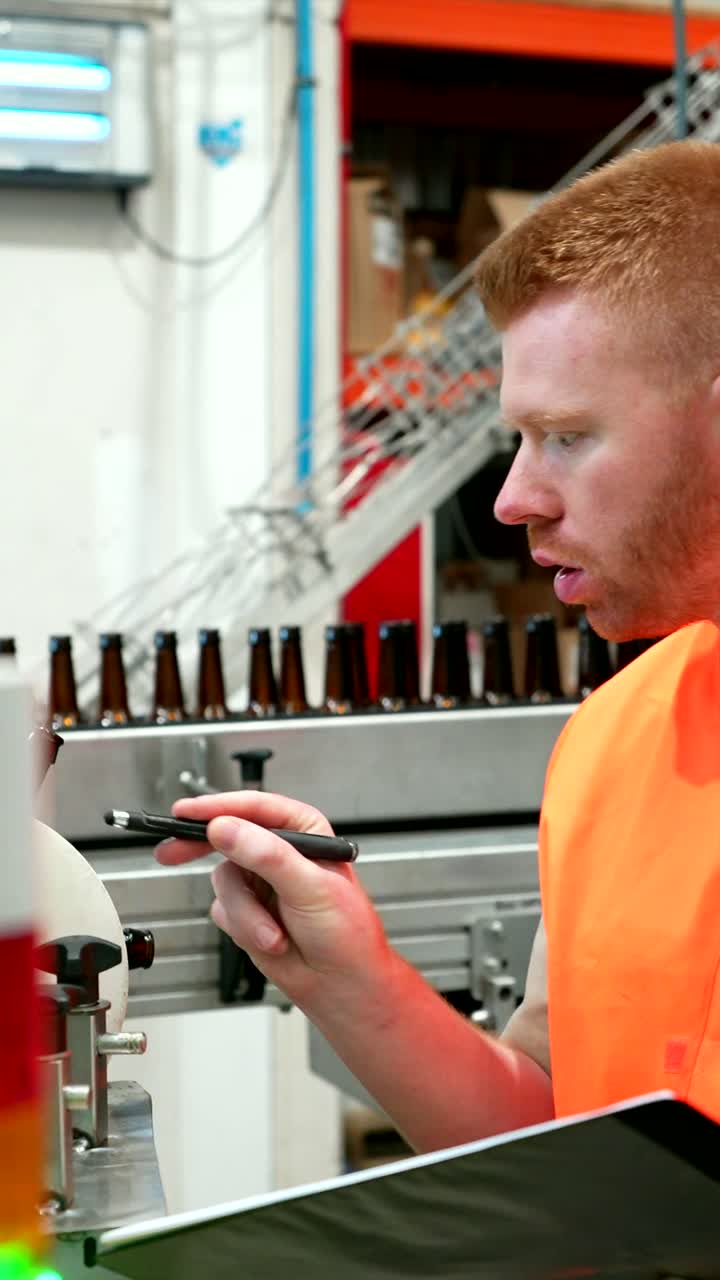 Man inspecting beer bottles on a conveyor belt