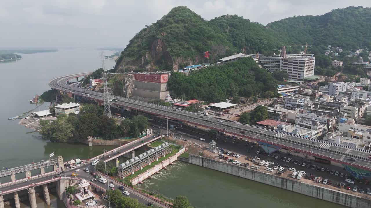 Dramatic landscape shot of Prakasam Barrage stretching across the Krishna River.