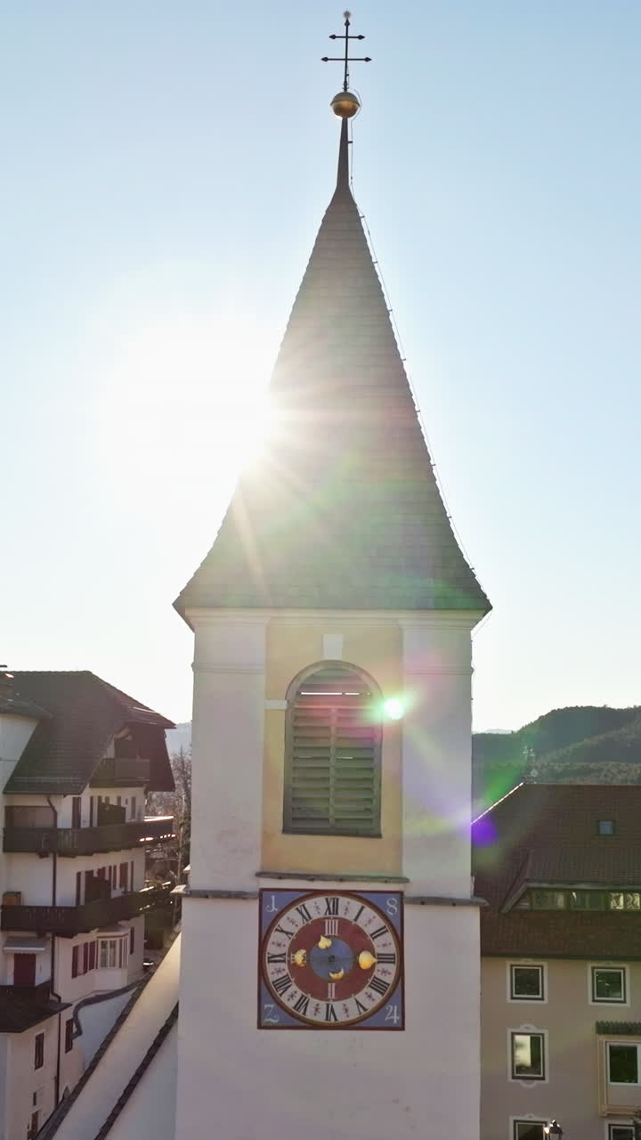 Aerial drone view of the church in Soprabolzano village on the Renon plateau in the Dolomites, Italy. Vertical