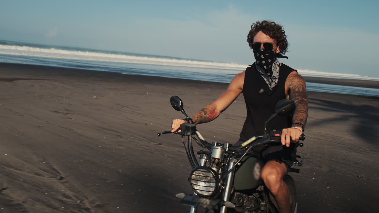 Man Riding Motorcycle on Beach