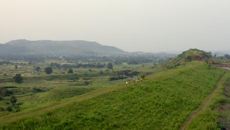 locals walking on the scenic landscape of karjat in india - aerial drone shot