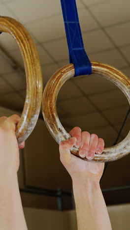 gymnast practicing with ring row