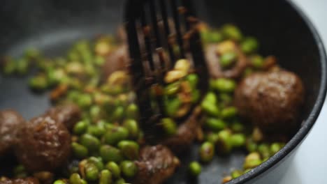 Anonymous-person-cooking-green-beans-and-meatballs