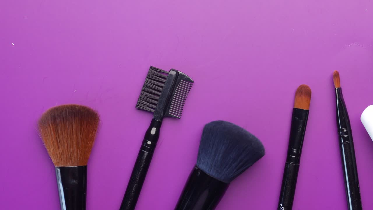 Beauty brush in a box on light purple background