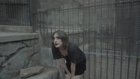 slow motion clip of a gothic woman model in a jail