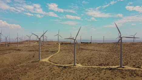 A-cluster-of-windmills-at-the-top-of-the-hill-connected-by-a-service-path