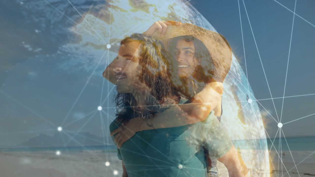 Man giving woman piggyback at beach, tech globe wrapping couple, data appearing, kissing lovingly