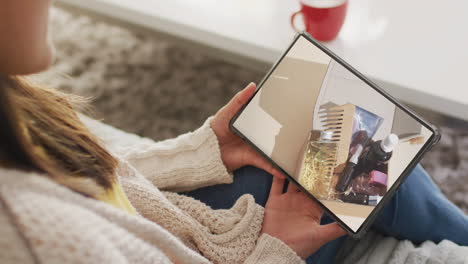 caucasian woman using tablet at home online shopping for beauty products, slow motion