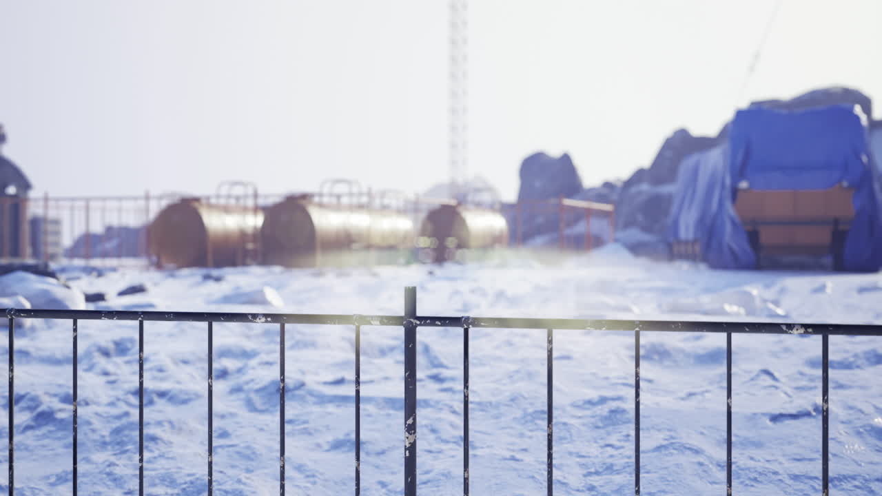 Frosty landscape with industrial elements under a bright winter sun