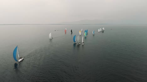 a sailboat race unfolds on a cloudy day in central europe