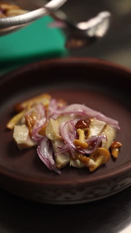 chef preparing a mushroom and fish dish