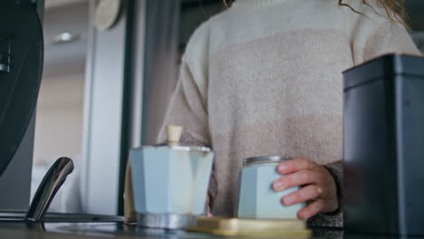 hands holding moka pot preparing aromatic morning coffee on kitchen close up.