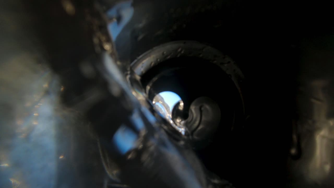 Careless tourist throws an empty soda or beer can into the ocean polluting the environment - view from inside the aluminum can