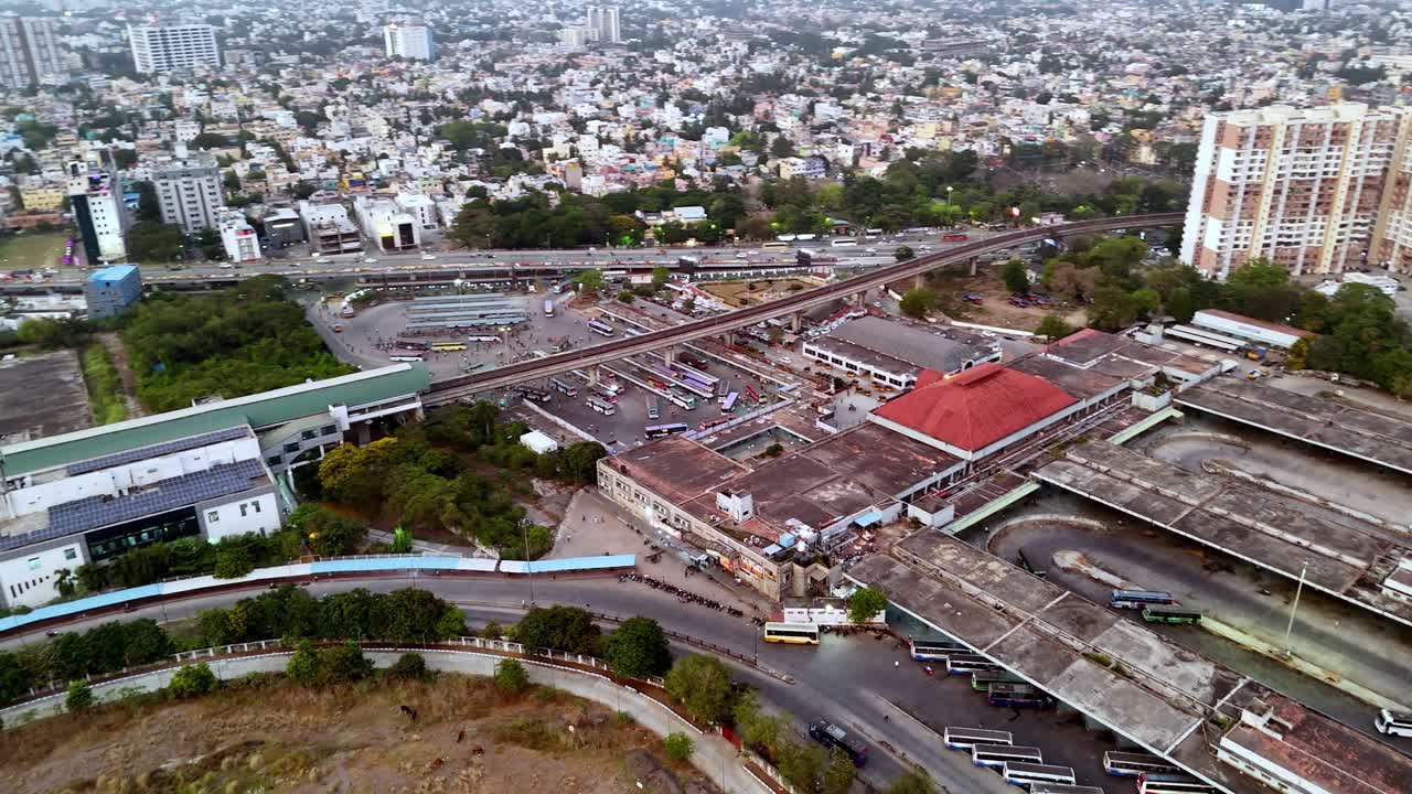Aerial view from the top of the Koyembedu Bridge in the heart of Chennai The glowing city lights and hazy sky illuminate the vast transportation hub and its surrounding high-rise skyline