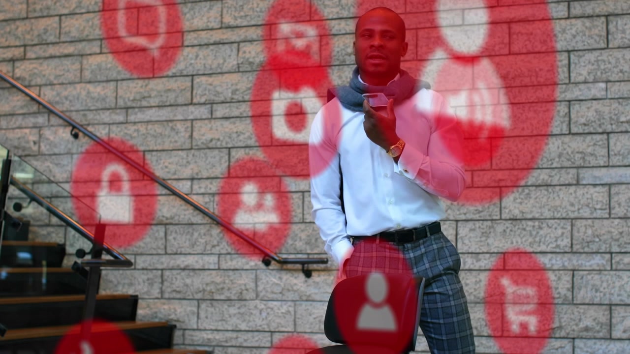 Animation of falling icons over african american man using smarphone
