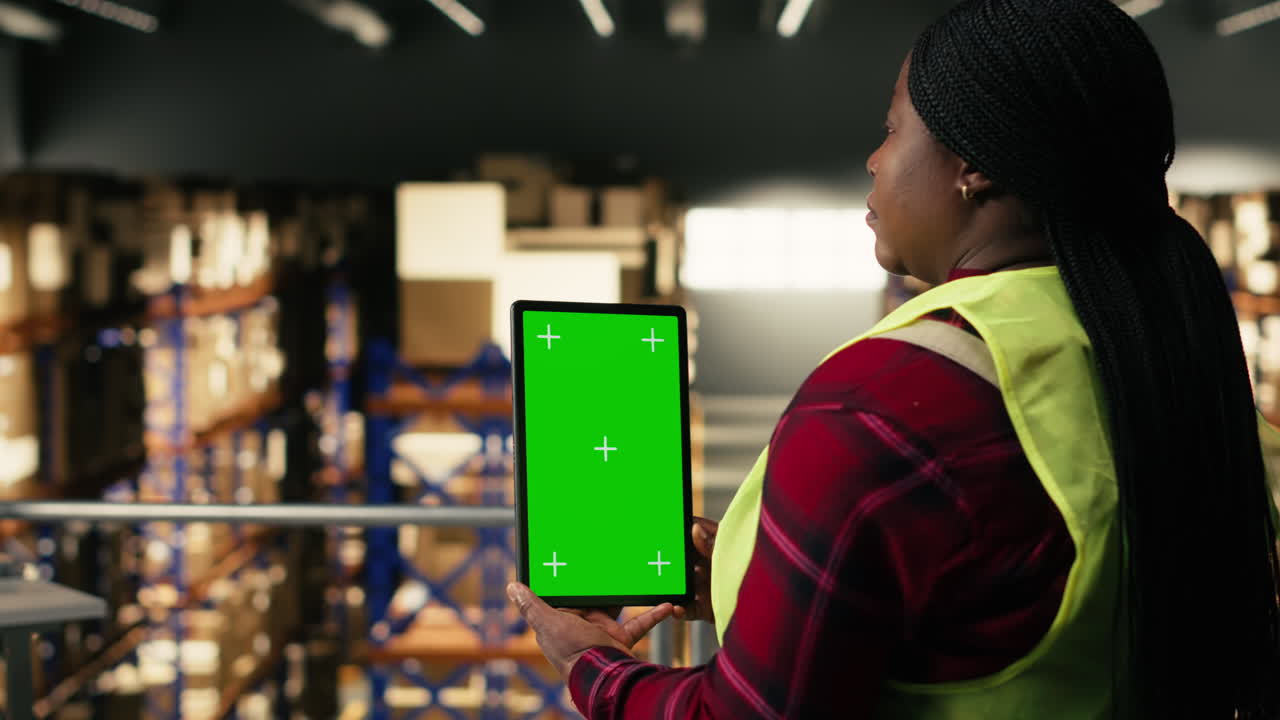 Warehouse Worker Holding Green Screen Tablet for Inventory Management