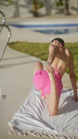 woman stretching outdoors by pool