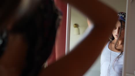mujer preparándose frente a un espejo