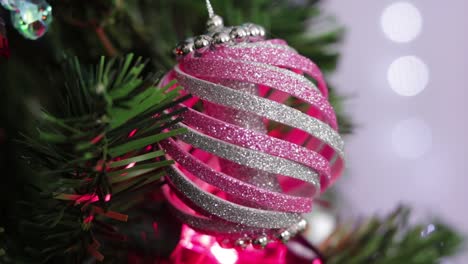 pink and silver glitter foam christmas ornament, hanging from the tree