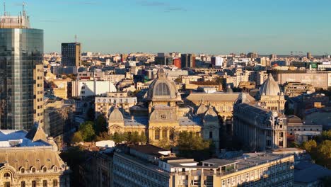 Aerial-Vista-of-the-CEC-Palace-with-the-Bucharest-Cityscape-Panning-Out-in-the-Background,-Romania