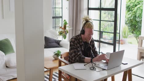 Happy-albino-african-american-man-with-dreadlocks-making-podcast