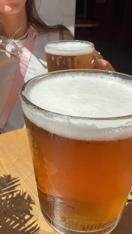 two women enjoying beers outdoors