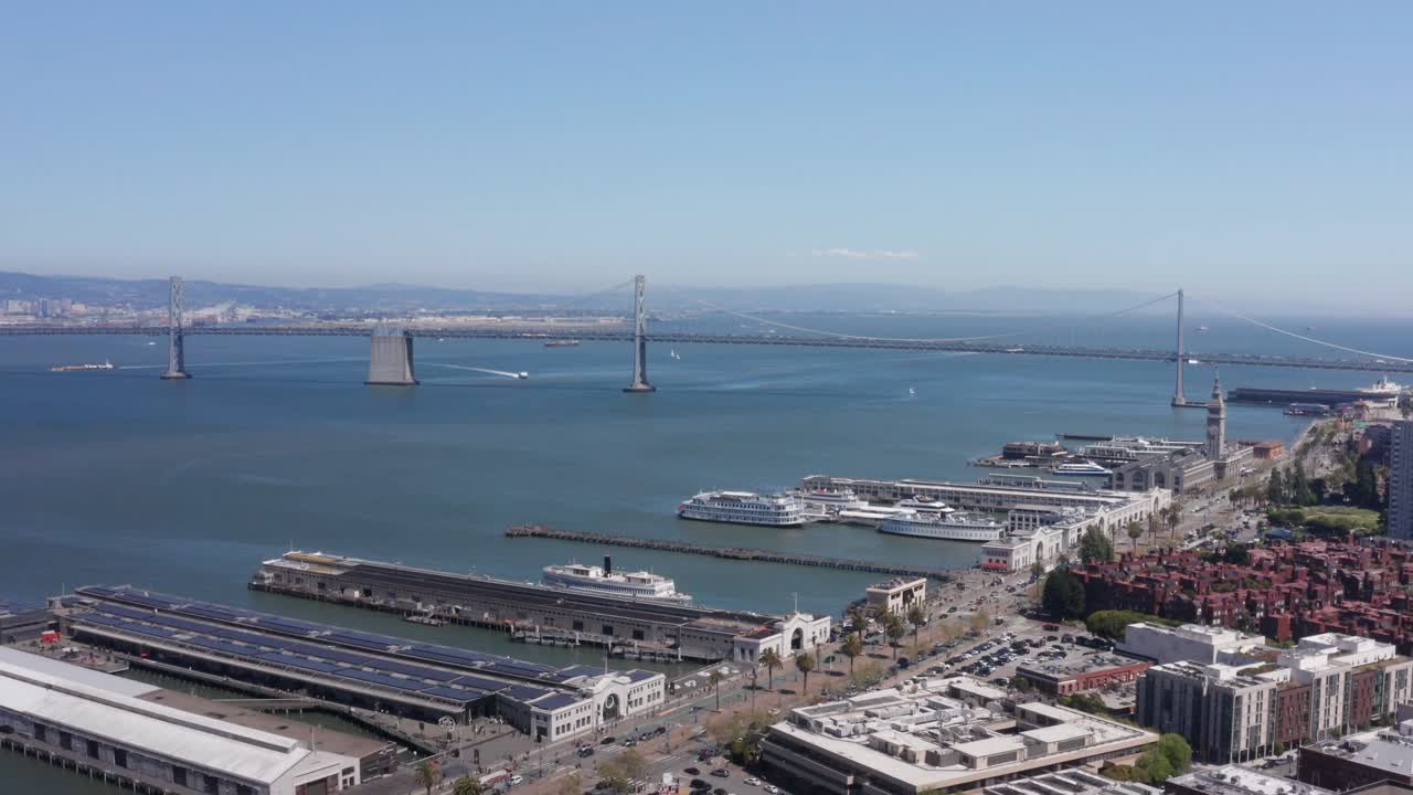 Wide aerial panning shot of the Embarcadero and Piers from Telegraph Hill in San Francisco, California