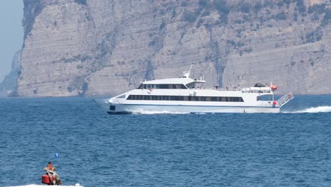 a ship cruises past cliffs in sorrento, italy