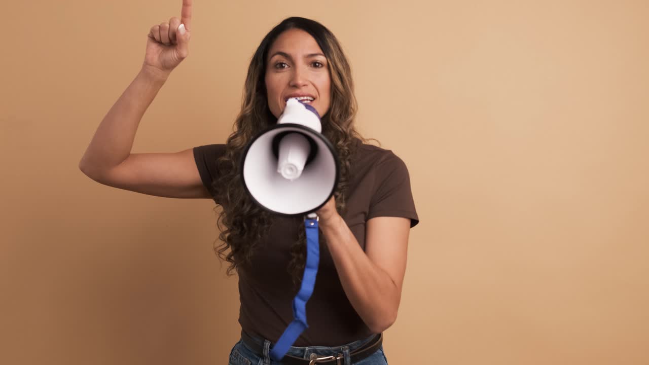 Woman using a loudspeaker and yelling positive