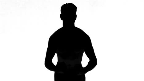 silhouette of a man tensing muscles on white background