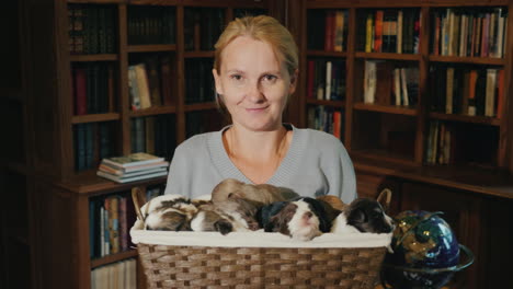 portrait of a woman with a basket full of little puppies