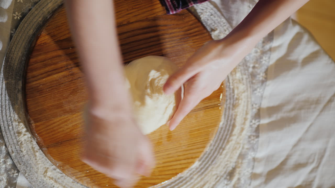 Close-Up - Hands Knead The Dough On A Wooden Board The Board Is Oiled With Vegetable Oil 4K Video