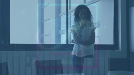 animation of financial data processing over biracial businesswoman in office