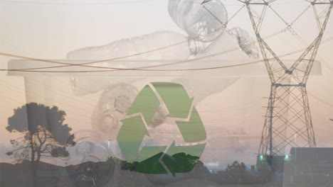 animation of green recycling sign over box with plastic bottles and electric pylons