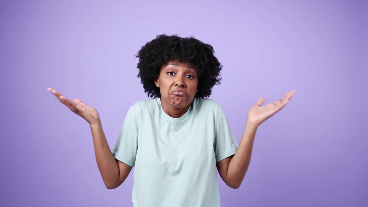 Young African American Woman Shrugging Shoulders with Confused Expression