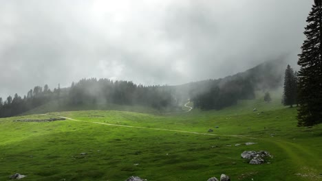 stormy foggy skyline aerial above green cinematic horror hills european countryside of slovenia, pungart, establishing intro shot