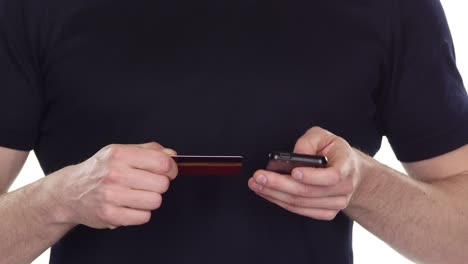 man using credit card and mobile phone for online payment