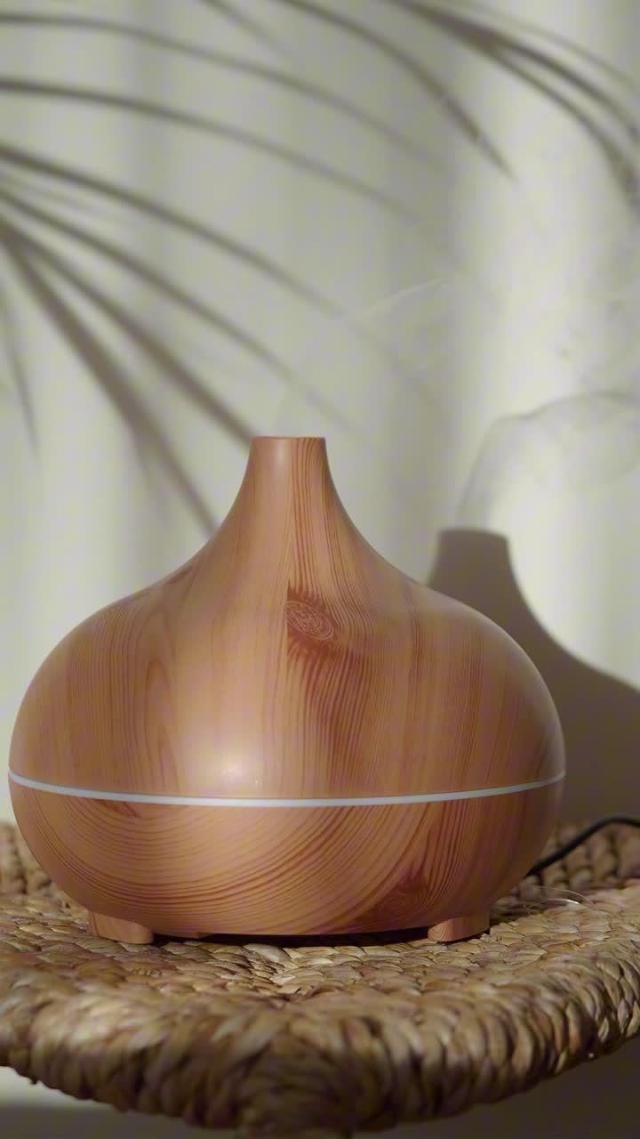 Wooden Essential Oil Diffuser Emitting Mist with Plant Shadow